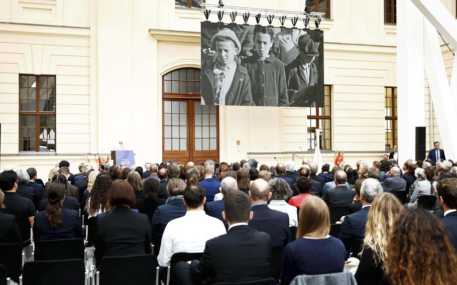 Guests watch the screening of the trailer of the film documentary "Reckonigs" at the Jewish Museum during at the commemorative event "70 Years of the Luxembourg Agreement" at the Jewish Museum in Berlin, Germany, Thursday, Sept. 15, 2022. 