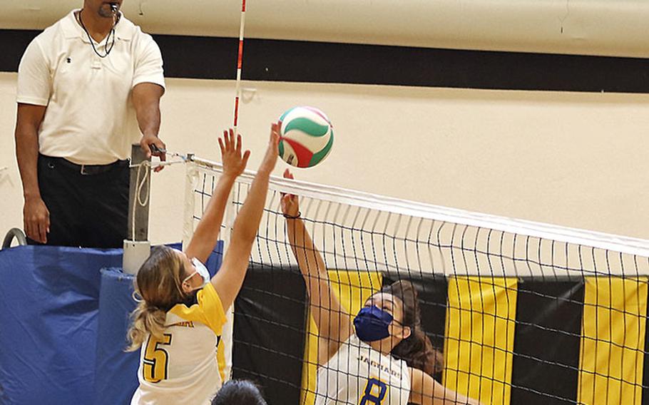 Sigonella's Marley Mcelree tries to get the ball over Vicenza's Shalom Dejardin during Saturday's game at Vicenza. The Cougars won in straight games, 25-12, 25-12, 25-10. 