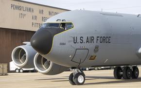 The nose of a gray airplane with the text “U.S. Air Force” emblazoned on it and  background denoting the Pennsylvania Air National Guard 171st Air Refueling Wing.