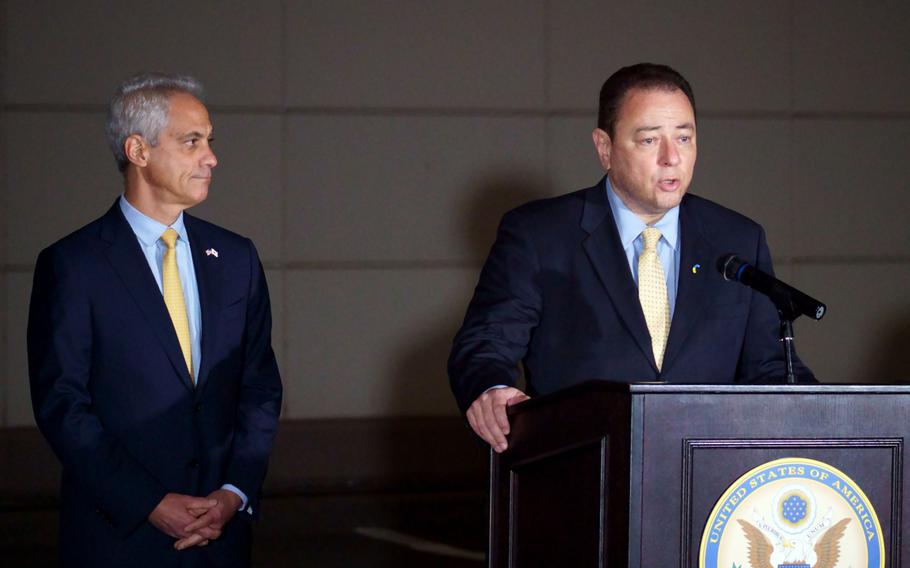 U.S. Ambassador to Japan Rahm Emanuel listens as his Ukrainian counterpart, Sergiy Korsunsky, speaks outside the U.S. Embassy in Tokyo, Wednesday, March 2, 2022. 