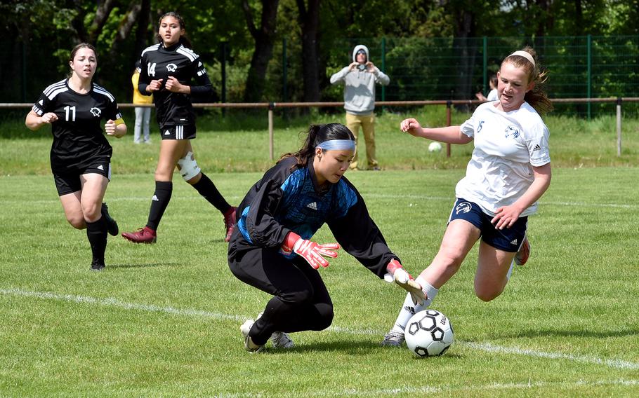 Vicenza goalkeeper Gia Barea beats Black Forest Academy forward Anna Yancy to the ball during a Division II semifinal of the DODEA European soccer championships on May 17, 2023, at VfR Baumholder's stadium in Baumholder, Germany.
