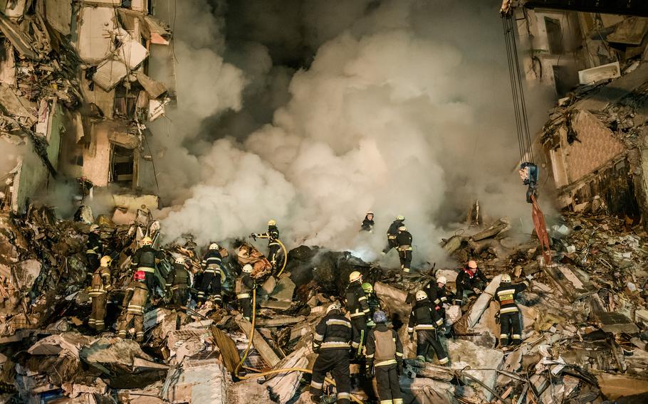 Rescuers work to free victims from the rubble of a residential apartment complex that was hit by Russian forces in Dnipro, Ukraine, on Saturday, Jan. 14, 2023. Several people were killed and more than 25 were injured, including children. The attack marked the most significant strike on the central Ukrainian city since the war began. Dnipro had until now served as a safe haven for thousands of displaced people from other regions.