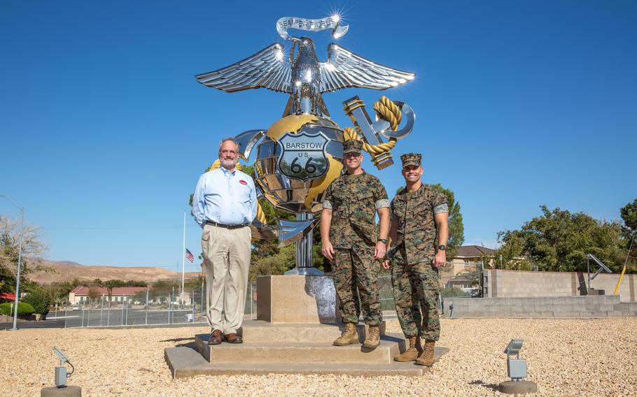 Marine Corps Maj. Gen. Joseph F. Shrader, center, the commanding general of Marine Corps Logistics Command, and Capt. Benjamin Leichty, right, join David R. Clifton, the executive deputy of the command, in front of the newly unveiled Route 66 Eagle, Globe and Anchor monument at Marine Corps Logistics Base Barstow, Calif., on Oct. 22, 2021. The monument was dedicated Nov. 9.