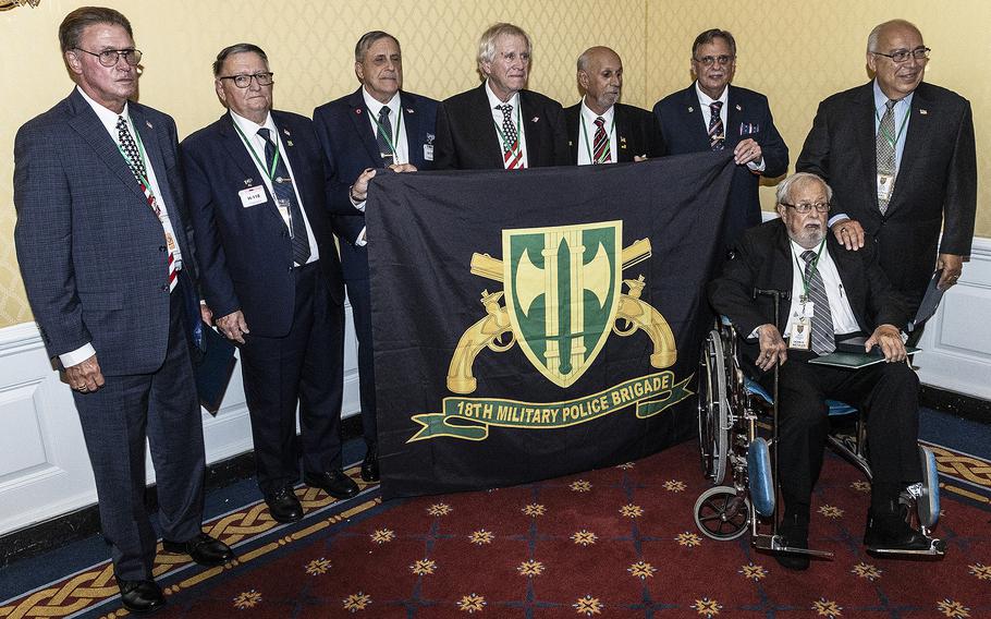 Veterans of B Company, 720th Military Police Battalion, 18th Military Police Brigade pose for a photo after receiving Bronze Star medals at a ceremony Monday, July 24, 2023, on Capitol Hill.