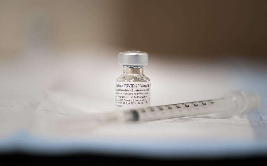 A vial of the COVID-19 vaccine is prepared to be administered at Walter Reed National Military Medical Center, Bethesda, Md., Dec. 21, 2020.