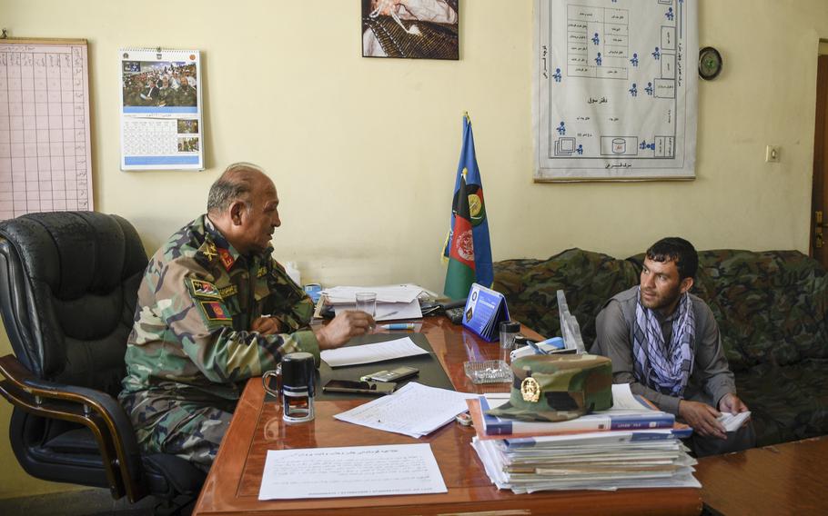 Lt. Col. Atiqullah Tarin, a recruiter for the Afghan army, speaks to Nasir Rahimi, in Charikar, Afghanistan June 5, 2021. Rahimi reenlisted as part of a drive to find 1,500 troops to replace departing U.S. and NATO troops at Bagram Airfield. 