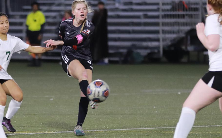 Nile C. Kinnick's Bree Withers boots the ball between two Robert D. Edgren players during Friday's DODEA-Japan girls soccer match. The Red Devils won 11-0.