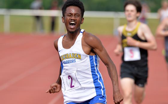 Wiesbaden’s Elijah Smith celebrates his win in the boys 3200-meter race at the DODEA-Europe track and field championships in Kaiserslautern, Germany. Smith set a new DODEA-Europe record, winning the race in 9 minutes 44.64 seconds, breaking the record of 9:49.21 set in 2019.