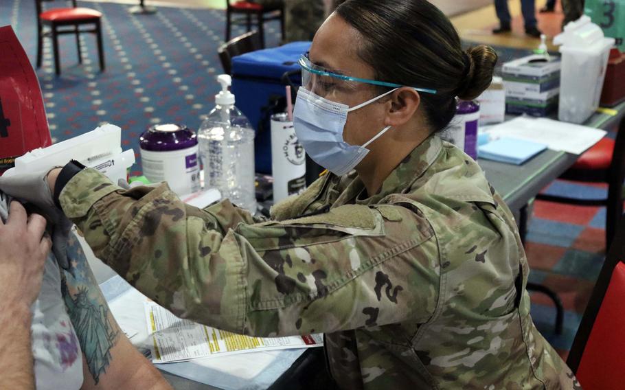 120p na            A soldier at Fort Bragg in North Carolina administers a coronavirus vaccine in February. MUST CREDIT: Sgt. Maj. Michael Noggle/U.S. Army.