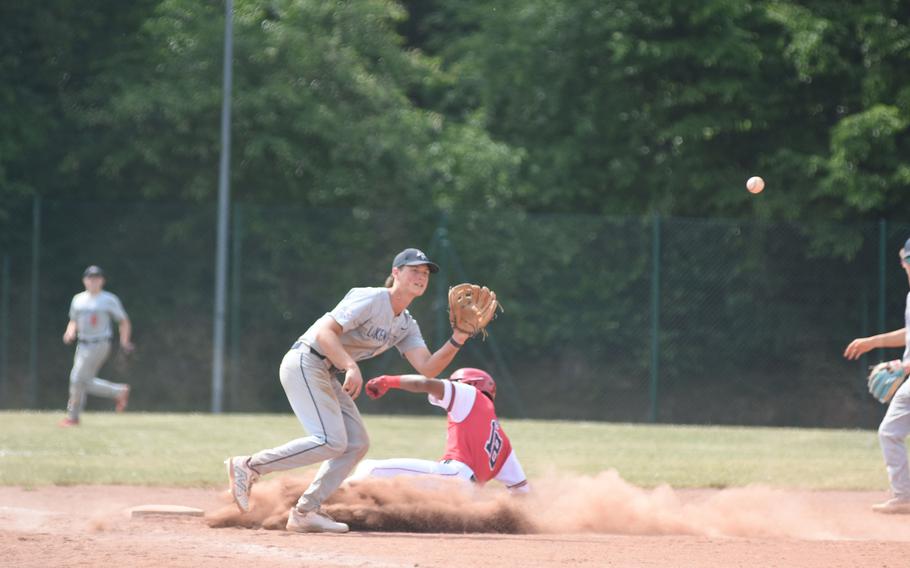 Kaiserslautern's Rueben Todman beats the throw to third before Lakenheath's James Arthaud can apply the tag Wednesday, May 21, 2025, on the opening day of the DODEA-Europe Division I baseball championships at Kaiserslautern, Germany.