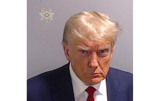 Former President Donald Trump poses for his booking photo at the Fulton County Jail on Thursday, Aug. 24, 2023, in Atlanta.