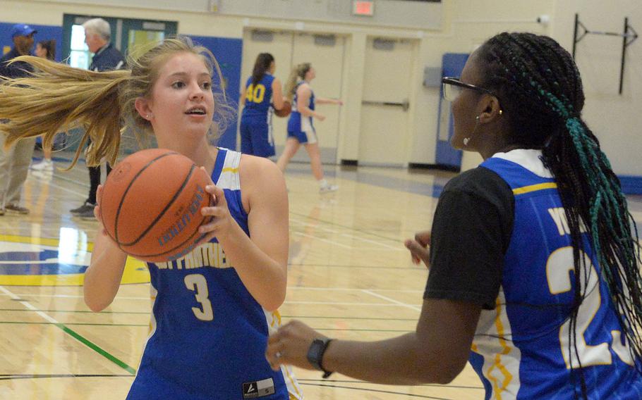 Yokota girls basketball returning sophomore Charlotte Rhyne looks for room against newcomer Beverly Gardner, a sophomore who transferred from Colorado Springs.