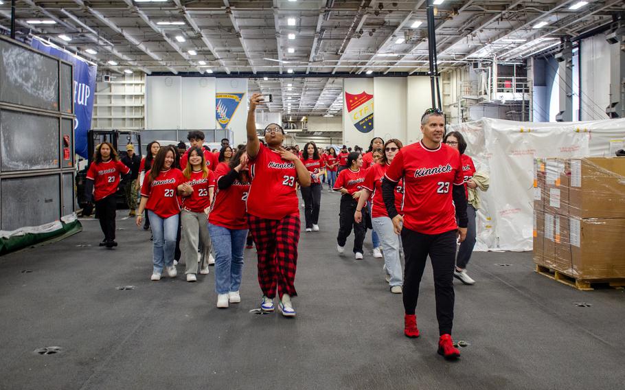 Seniors from Nile C. Kinnick High School tour the aircraft carrier USS Ronald Reagan at Yokosuka Naval Base, Japan, April 18, 2023.