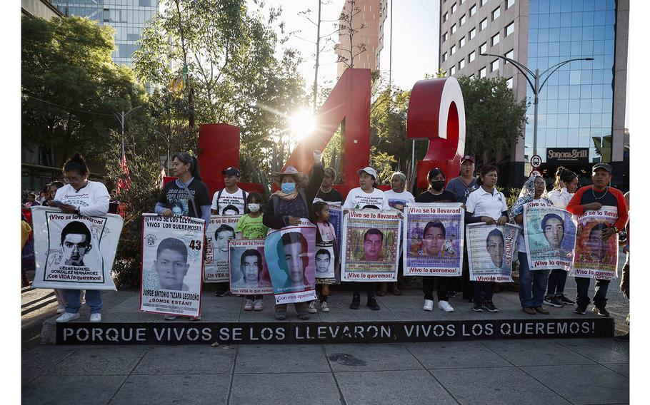 Relatives of the Ayotzinapa victims hold banners in Mexico City on Jan. 26, 2024, during a protest against the liberation of Army members linked with the disappearance of the 43 students of the Ayotzinapa teaching training school.