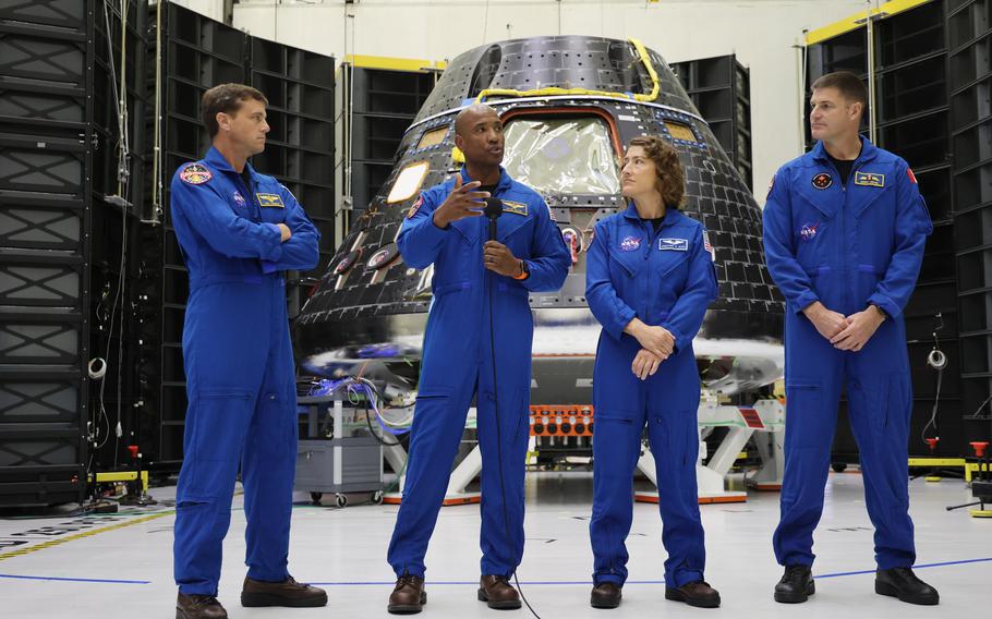 Artemis II astronauts, from left: Commander Reid Wiseman; Pilot Victor Glover; and Mission Specialists Christina Hammock Koch; and Jeremy Hansen; in front of the Artemis II Crew Module during Orion Media Day at Kennedy Space Center, on Tuesday, Aug. 8, 2023. 