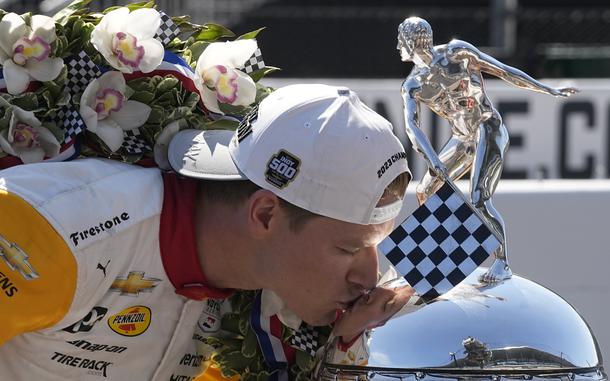 Josef Newgarden kisses the Borg-Warner Trophy during the traditional winners photo session at Indianapolis Motor Speedway, Monday, May 29, 2023, in Indianapolis. Newgarden won the 107th running of the Indianapolis 500 auto race Sunday. (AP Photo/Darron Cummings)