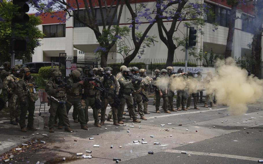Border Patrol personnel deploy tear gas.