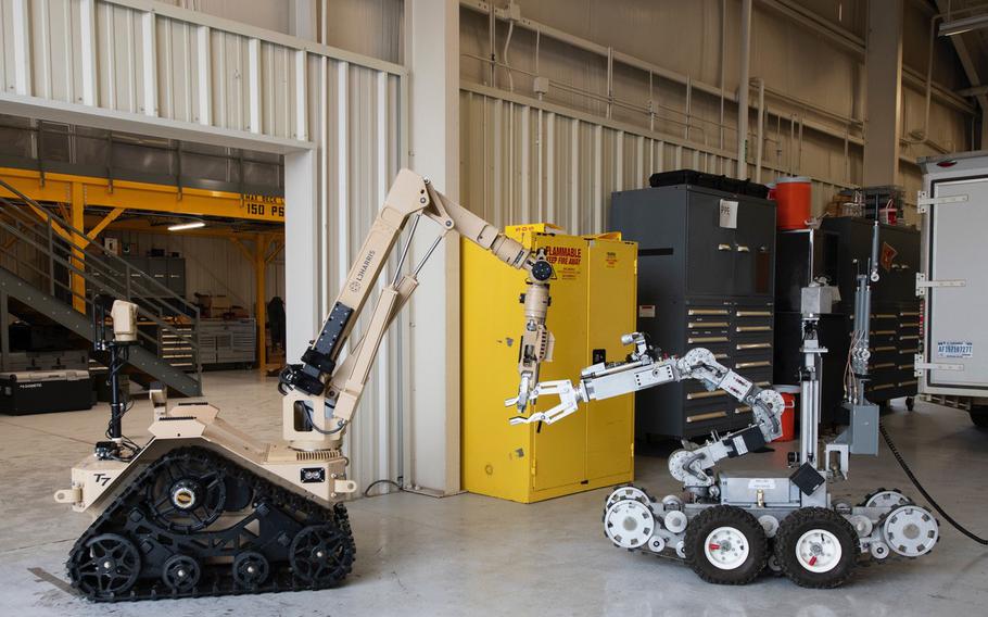 The T7, left, the newest explosive ordnance disposal robot in the Air Force, operates next to its predecessor, the F6A, at Eglin Air Force Base, Fla., on Aug. 25, 2022. 
