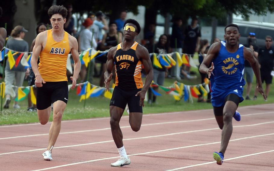 Kadena's Neil Kentish, middle, outlasts ASIJ's Oisin Kaiyo and Yokota's Baron Reed to win the 100 and 200.