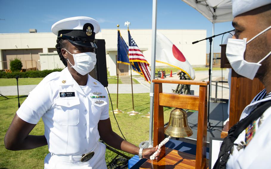 A sailor rings a bell to honor the fallen during the first Bells Across America ceremony at Yokosuka Naval Base, Japan, Thursday, Sept. 23, 2021. 