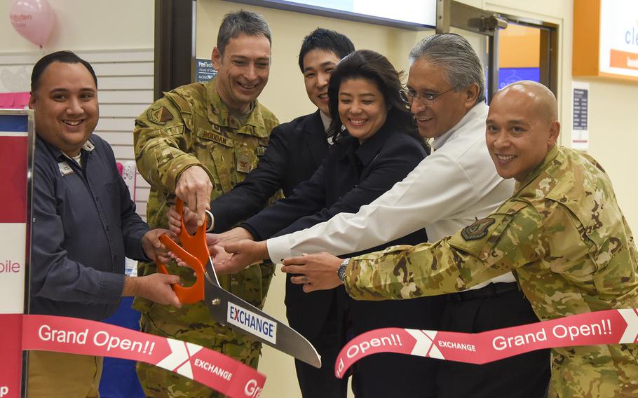 From left, Andrew Defelice, Yokota exchange general manager, and Col. Andrew Roddan, 374th Airlift Wing commander, with employees of Rakuten Mobile open the company’s branch at Yokota Air Base, Japan, on Dec. 22, 2023. 