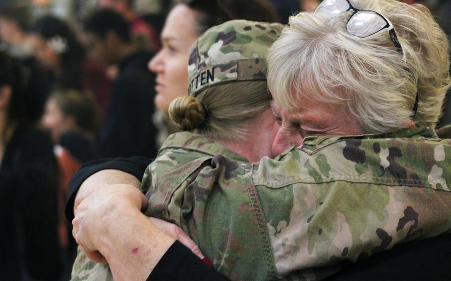 The families and friends of U.S. Army soldiers with the 4th Infantry Division hug their loved ones at a welcome home ceremony Sep. 13, 2023, at Fort Carson, Colo. The Soldiers returned from Europe, where they were deployed.