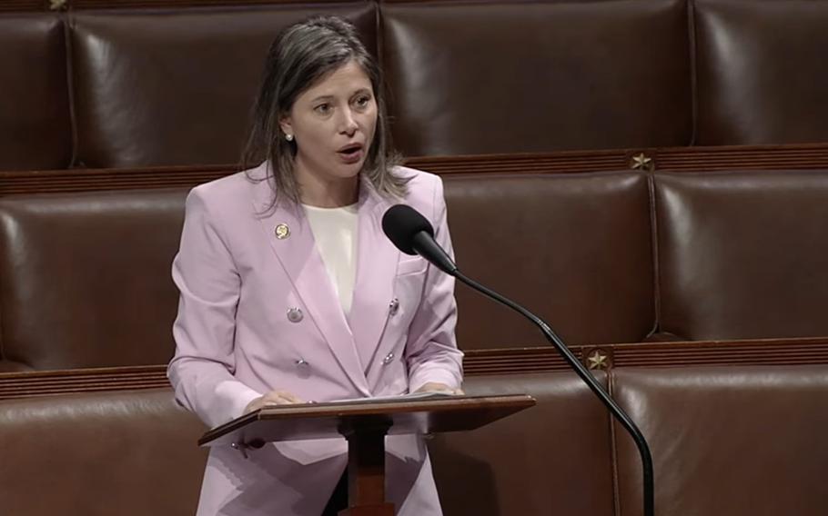 A woman speaks at a podium
