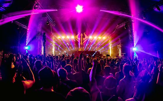 Colorful lights illuminate a dance party.