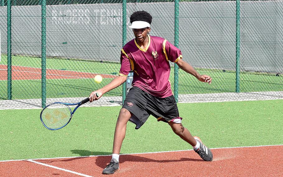 Vilseck's Cameron Holloway slides to hit a ball during a singles match on Sept. 23, 2023, at Kaiserslautern High School in Kaiserslautern, Germany.