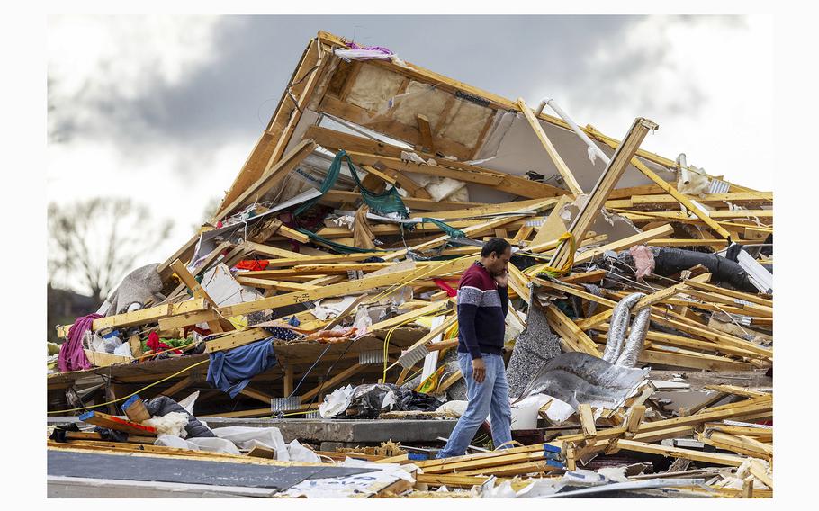 Gopala Penmetsa walks past his house after it was leveled by a tornado near Omaha, Neb., on Friday, April 26, 2024. 