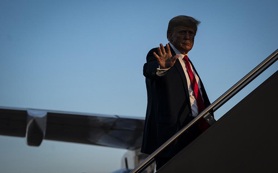Former president Donald Trump boards a plane after a campaign event on April 27, 2023, in Manchester, N.H. 