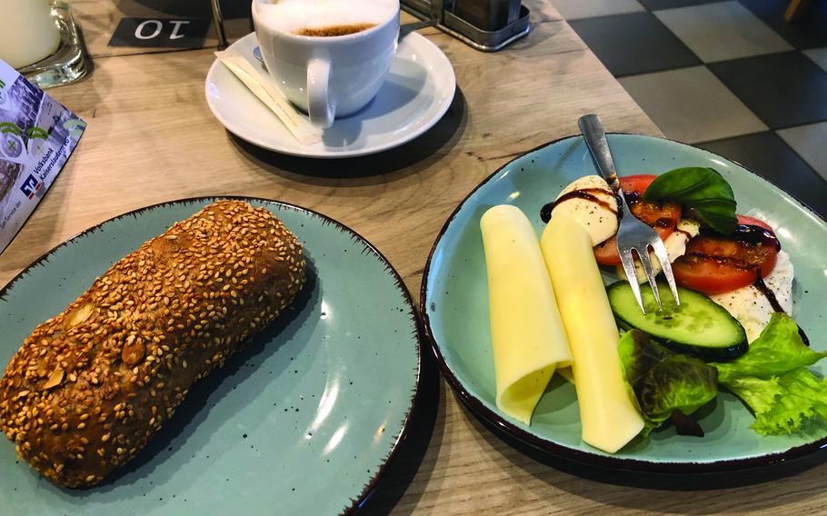 The vegetarian breakfast at Cafe Hinz in Kaiserslautern, Germany, includes a wheat roll and a plate of cheese and vegetables.