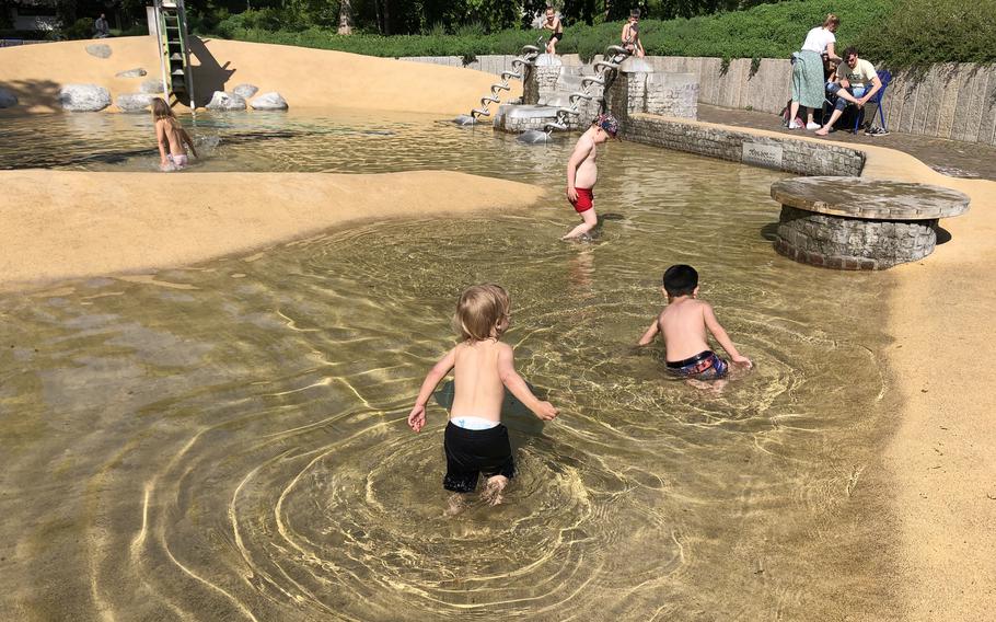 Children swim at the water playground at Luisenpark in Mannheim, Germany, on Friday, May 6, 2022.