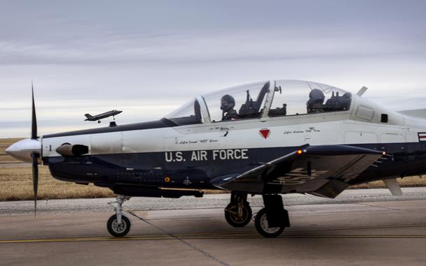 A Euro-NATO Joint Jet Pilot Training program pilot in the back seat of a T-6A Texan II watches as an F-35A Lightning II lands at Sheppard Air Force Base, Texas, Jan. 10, 2019. Four F-35s from Eglin AFB, Fla., stopped at Sheppard as part of an undergraduate pilot training base road tour to show the aircraft to 80th Flying Training Wing student pilots as well as provide capability briefings. Some F-35 aircraft maintenance Airmen in training from the 82nd Training Wing were also able to get an up close look at the fifth-generation fighter and talk with active duty maintenance Airmen. (U.S. Air Force photo by John Ingle)
