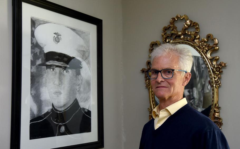 Patrick Smithwick is the author of “War’s Over, Come Home” about his search for his son, Andrew, who became homeless after serving two tours in Iraq. Here, he stands near a portrait of Andrew that is displayed in his home on May 17, 2023.