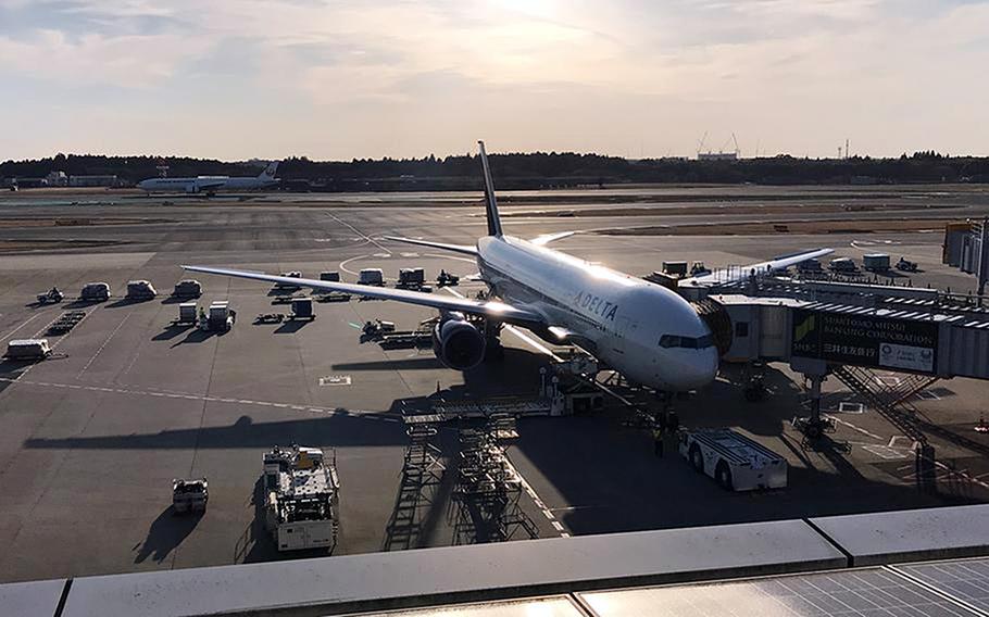 A U.S.-bound plane is parked at a gate at Narita International Airport in Japan in 2019. The Defense Department will roll out a replacement to the Defense Travel System over the next three years.