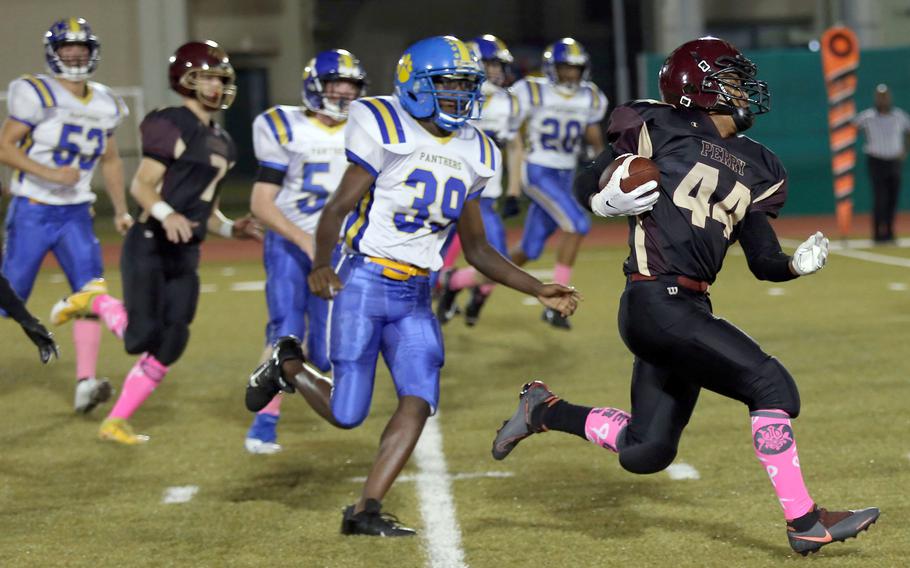 Matthew C. Perry's Denzel Gray eludes the tackle of Yokota's Jamari Fields.