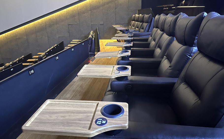 ScreenX moviegoers are guided to their seats by numbers displayed behind leather recliners and on foldable tray tables at I’Park Mall in Seoul, South Korea.