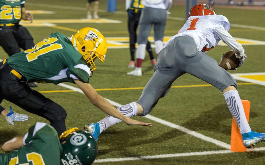 Nile C. Kinnick's Ryo Nishiyama stretches for the end zone ahead of Robert D. Edgren defenders.