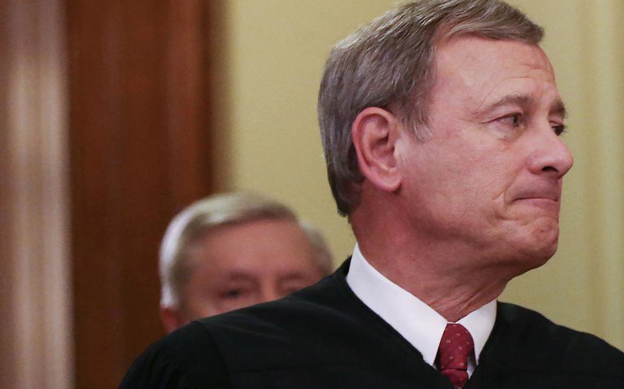 Supreme Court Chief Justice John Roberts, right, departs the Senate chamber along with Sen. Lindsey Graham, R-S.C., on Feb. 5, 2020, in Washington, D.C. 