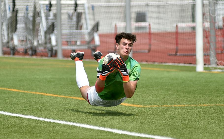 Lakenheath goalkeeper Matthew Vasquez falls to the turf as he corrals a loose ball during a Division I semifinal match against Stuttgart at the 2025 DODEA European championships on May 21, 2025, at Kaiserslautern High School in Kaiserslautern, Germany.