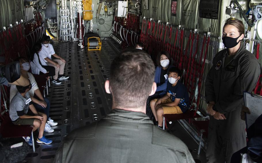 Marine Cpl. Andrew Campbell, a KC-130J Super Hercules loadmaster, tells Japanese chidren about the missions the aircraft has supported over the years, during a tour of Marine Corps Air Station Iwakuni, Japan, Thursday, Sept. 23, 2021. 