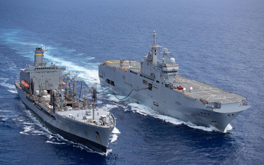 The U.S. Navy oiler Big Horn, left, replenishes the French navy’s Tonnerre in the Philippine Sea in 2021. The Navy unveiled its climate action plan Tuesday, but the strategy doesn’t address reduction of carbon emissions from ships and aircraft.