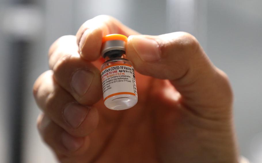 A pharmacist inspects a pediatric COVID-19 vaccine vial at Brian D. Allgood Army Community Hospital on Camp Humphreys, South Korea, Nov. 17, 2021. 