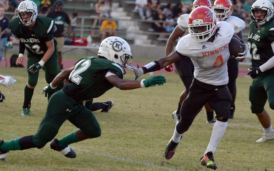Nile C. Kinnick's Tre Bennett tries to avoid Kubasaki's Haustyn Lunsford.