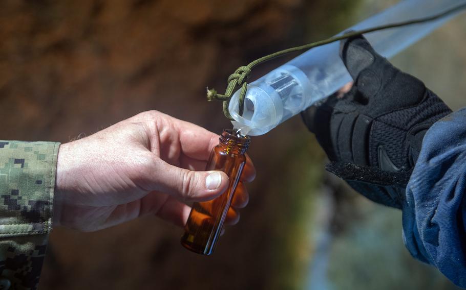 Navy personnel collect a water sample from the Red Hill well in Hawaii in March 2022.