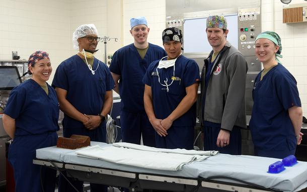 Dr. Bryan Curtis, second from left, an Air Force colonel and chief of plastic and reconstructive surgery for the 60th Surgical Operations Squadron at Travis Air Force Base, Calif., poses with his Athena team at Yokota Air Base, Japan, April 12, 2024.