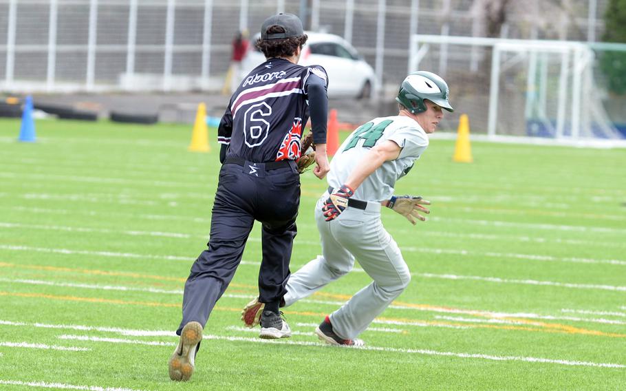 Zama’s Blaeson Moore tries to chase down Kubasaki’s Andrew Welte during Friday’s first of four games for the Dragons in 24 hours.