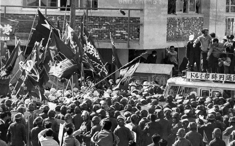 About 1,000 Okinawan riot police form a shield around 162 Japan Ground Self-Defense Force cadets in Naha, Okinawa, Feb, 29, 1972. The arrival of the cadets for a tour and study of the Battle of Okinawa sparked a demonstration by nearly 700 people.