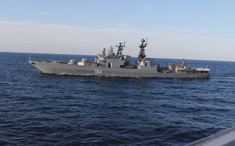 A Russian Udaloy-class destroyer passes the USS Chafee in the Sea of Japan on Oct. 15, 2021.